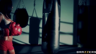 Boxer girl Aryana Augustine hitting the bag in the gym