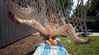 Aria Kai is playing with the dildo outdoors