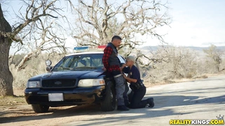 Cop Bridgette B is sucking cock outdoors