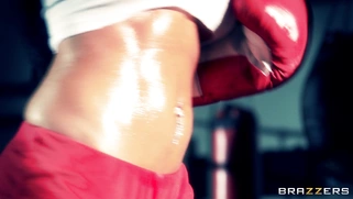Boxer girl Aryana Augustine hitting the bag in the gym