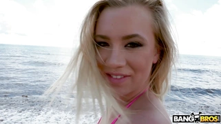 Blonde Bailey Brooke takes sunbathes on the beach